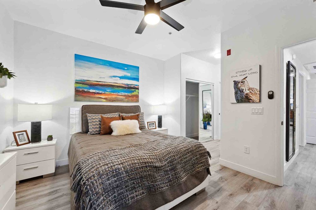 a bedroom with a bed and a ceiling fan