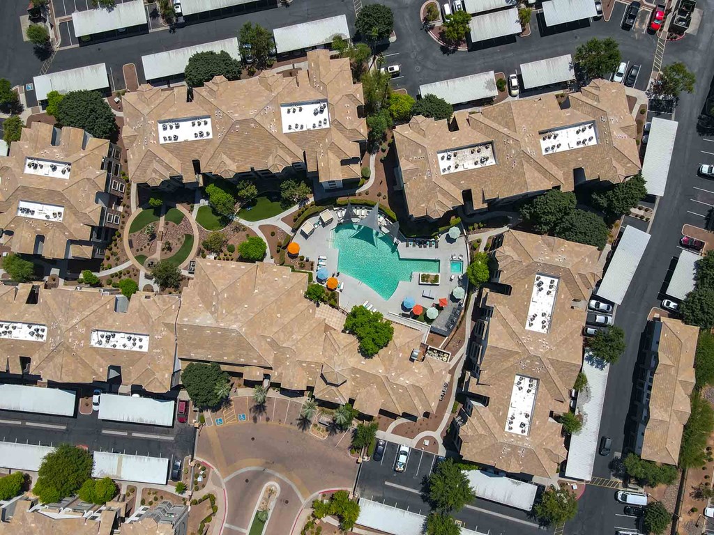 arial view of a large mansion with a swimming pool in the middle of it