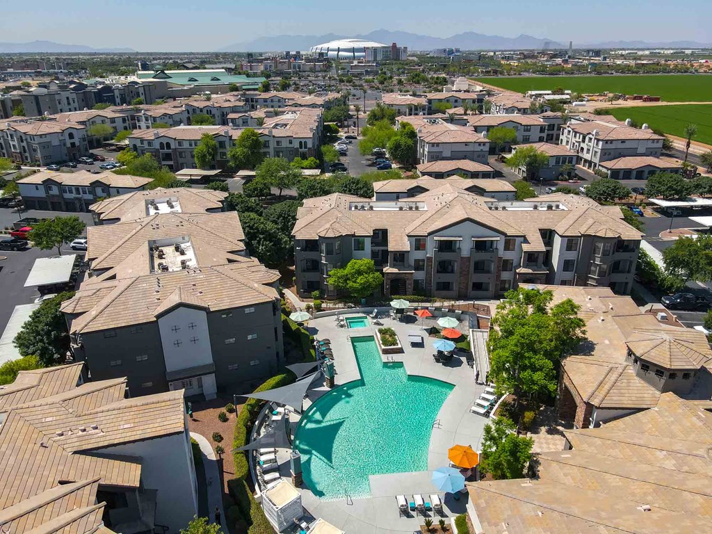 an aerial view of a community with a large swimming pool in the middle of it