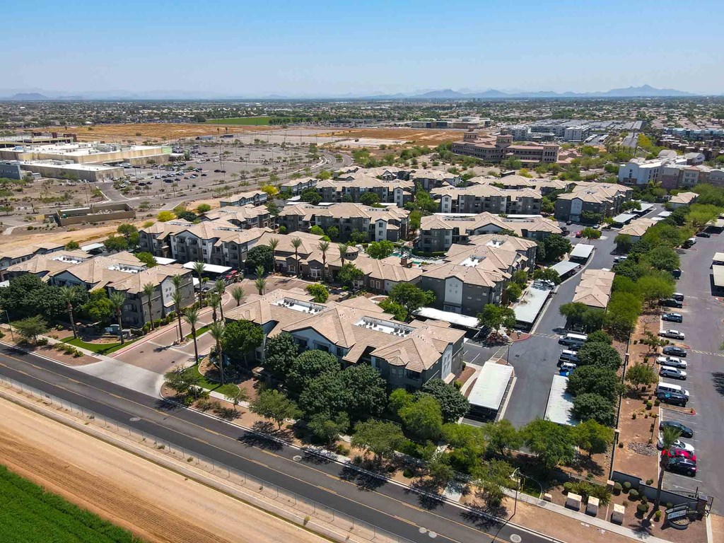 an aerial view of a neighborhood with cars parked on the side of the road