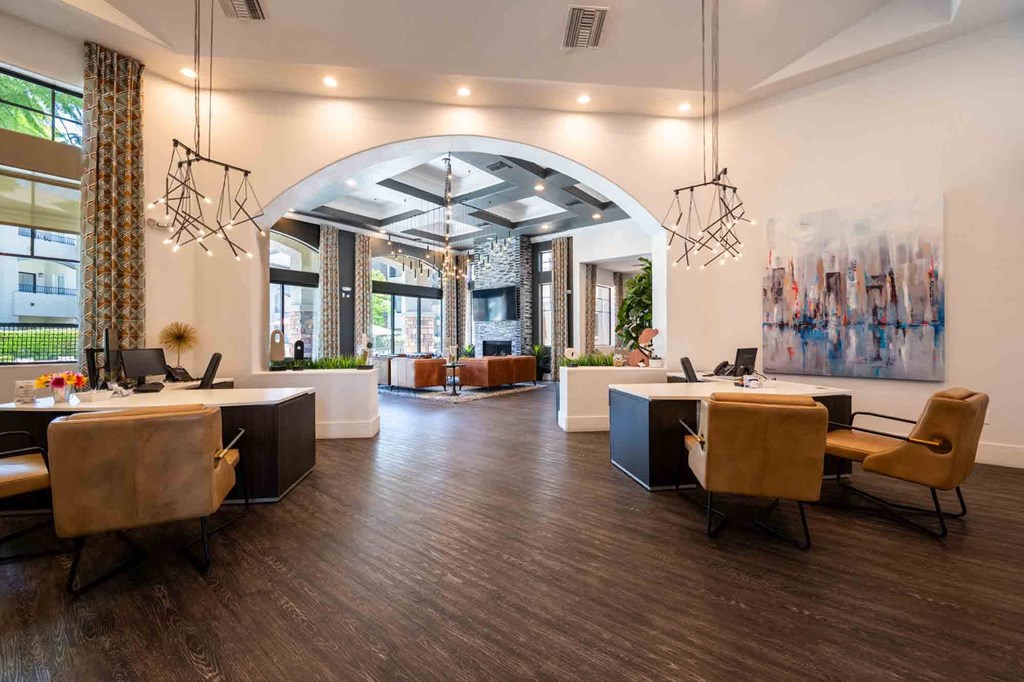 a large room with tables and chairs and a large archway