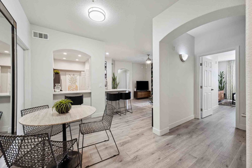 a dining area with a round table and four chairs