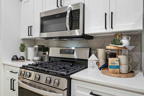 a kitchen with a stove and a microwave