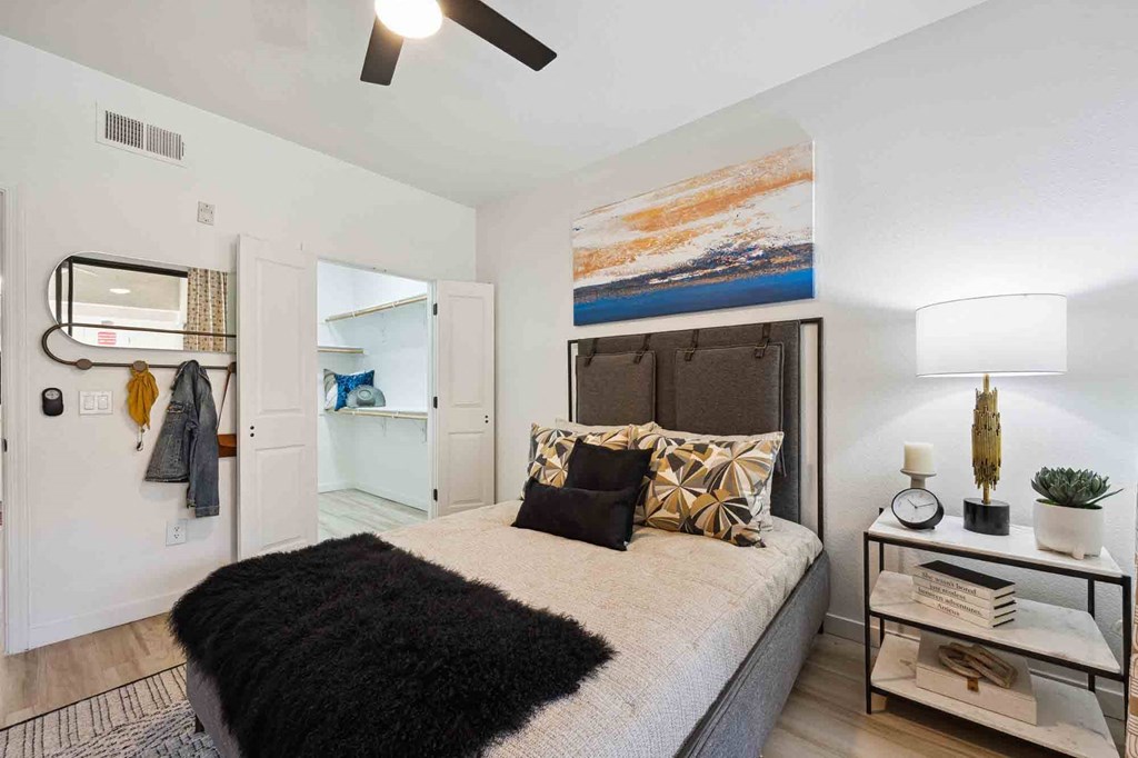 a bedroom with a bed and a ceiling fan