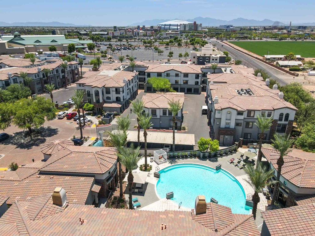 an aerial view of a resort style community with a large swimming pool