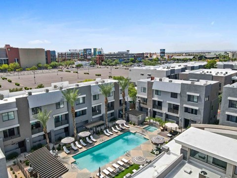 an aerial view of an apartment complex with a swimming pool