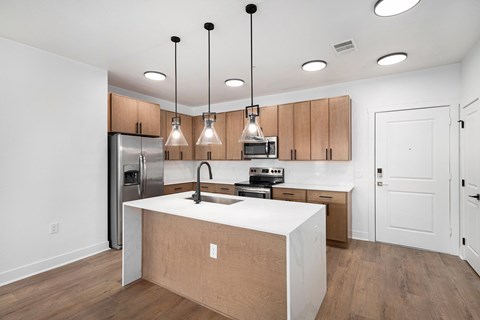 A kitchen with wooden cabinets and a white countertop.