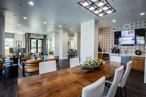 A modern dining room with a wooden table and chairs.