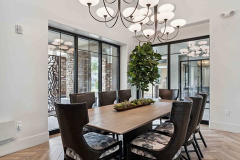 A dining room with a wooden table and chairs.