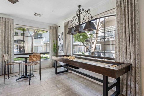 A dining room with a wooden table and chairs.