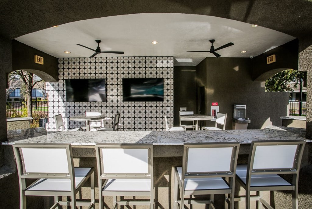 a bar with chairs and a counter in a restaurant