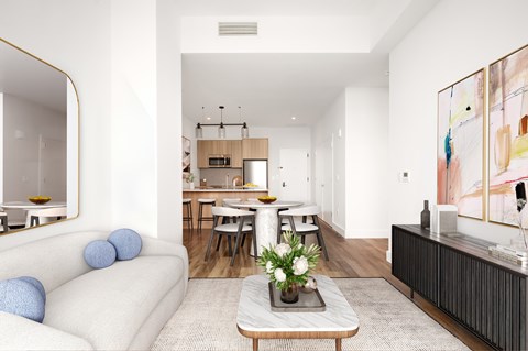 A modern living room with a white sofa and a coffee table.