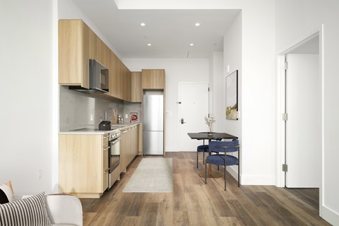 A modern kitchen with a dining table and chairs.