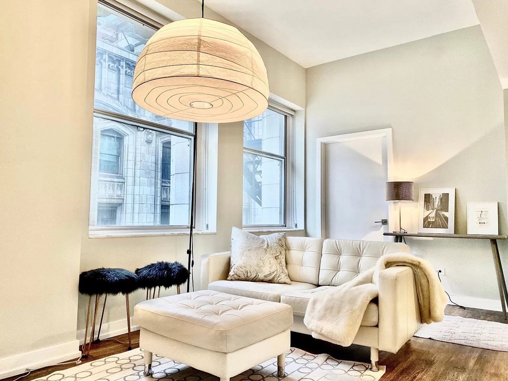 a living room with a white couch and a large window