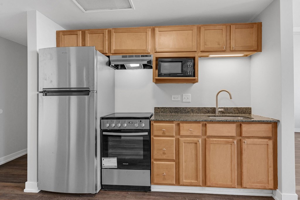 a kitchen with stainless steel appliances and wooden cabinets