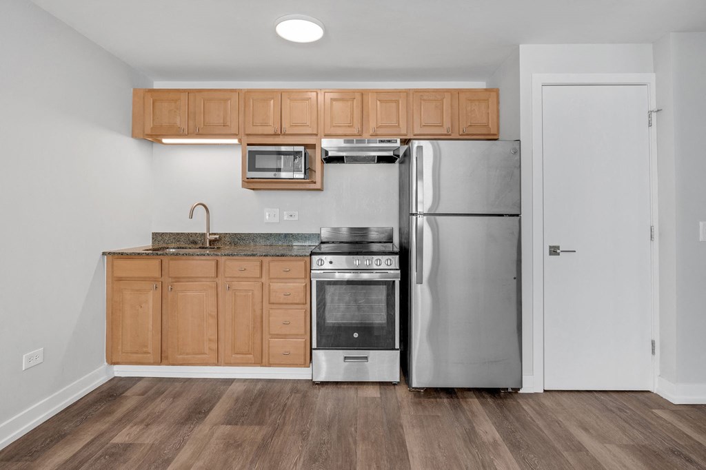 a kitchen with stainless steel appliances and wooden cabinets