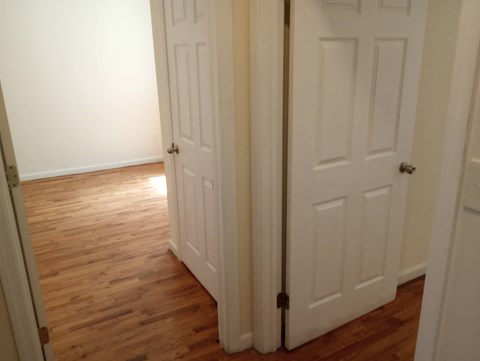 A white door is closed and has a black handle.