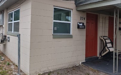 A house with a red door and a sign that says 204.