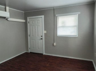 A room with a door and a window.