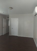 A room with a white door and a window.