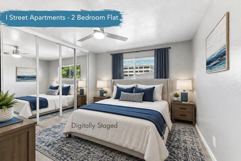 A bedroom with two beds and a ceiling fan.
