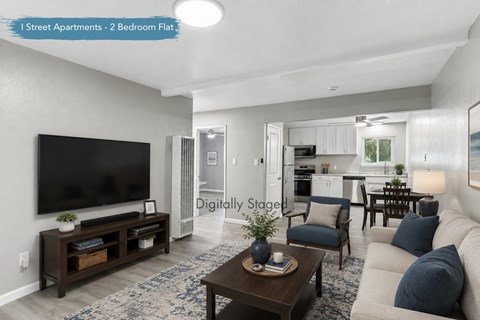 A living room with a flat screen TV and a coffee table.