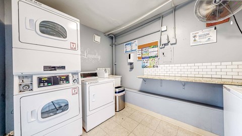 A laundry room with a washing machine and a dryer at Pennsylvania Place, Davis, CA