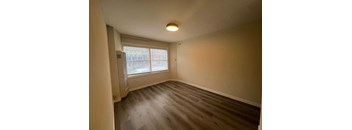 Empty room with a window and a door.