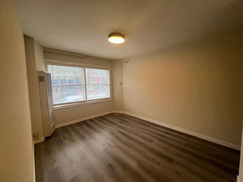 Empty room with a window and a door.
