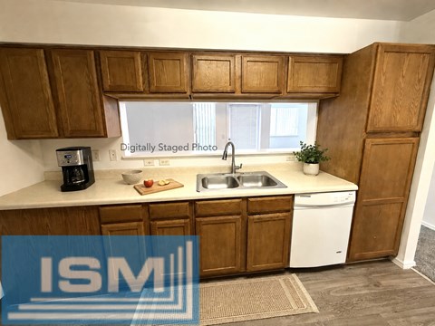 A kitchen with wooden cabinets and a white dishwasher.