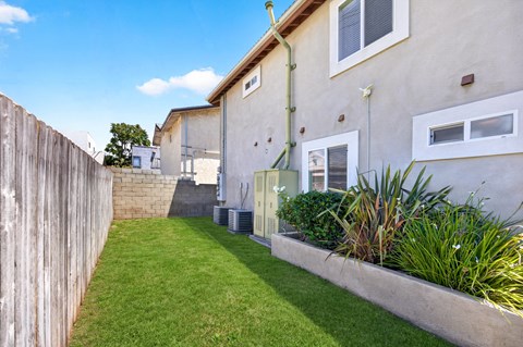 A house with a green lawn and a wooden fence.