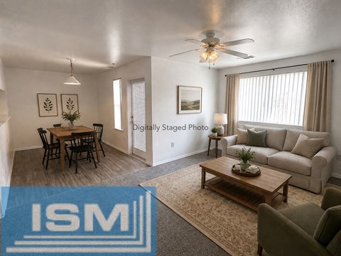 A living room with a dining table and chairs.