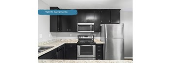 Modern kitchen with black cabinets and stainless steel range at OSM Properties Homes & Apartments, California, 95926