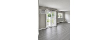A room with a sliding glass door and a window.