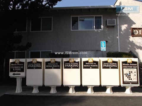 A series of signs for Menlo Pointe Clubhouse and parking.