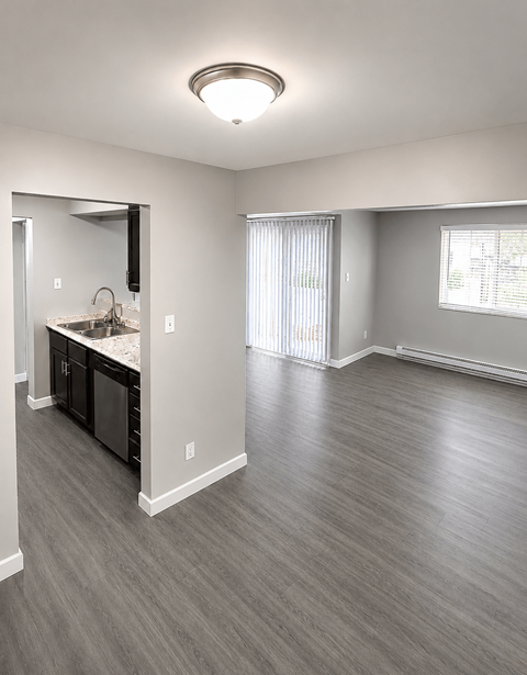 A spacious room with a sink and a mirror.