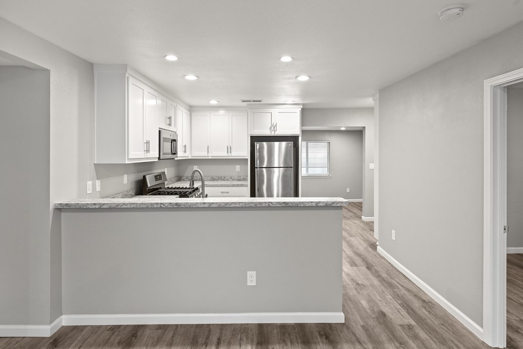A kitchen with a counter and cabinets. A kitchen with a counter and cabinets.at OSM Properties Homes & Apartments, California