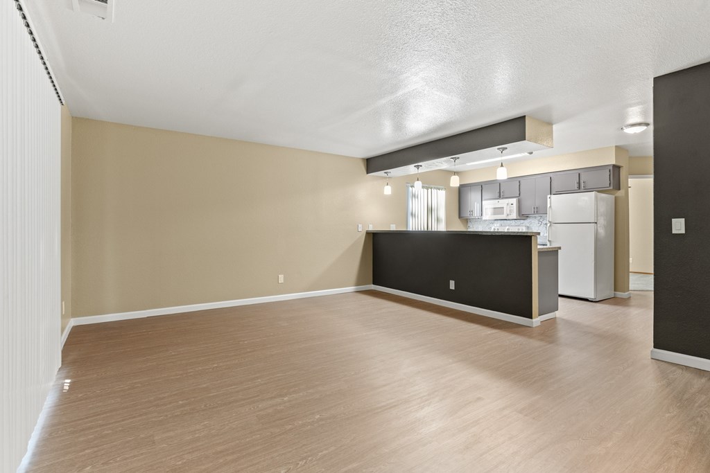 A kitchen area with a black countertop and wooden flooring.at Redwood Cove Apartments, Chico, 95928  