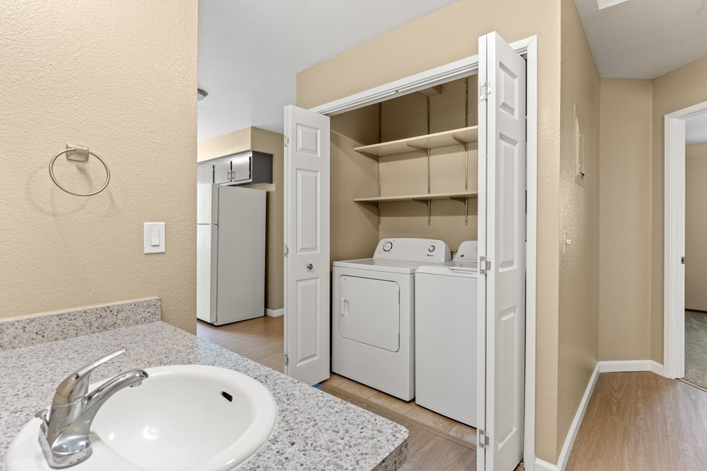 A white sink with a silver faucet in a bathroom.at Redwood Cove Apartments, Chico, 95928  