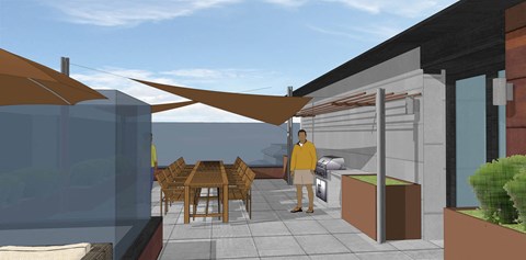 A man in a yellow shirt stands on a patio.