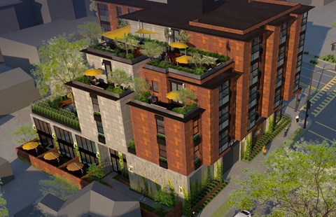 A modern building with a green roof and balconies.