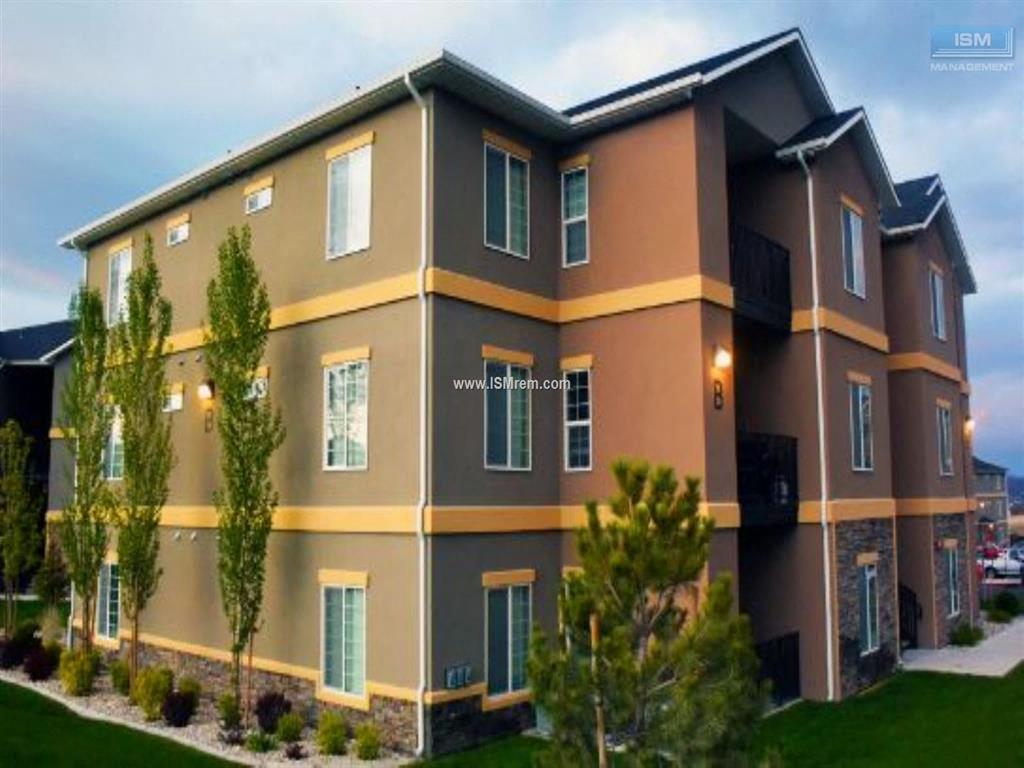 A modern two-story building with a balcony on the second floor.