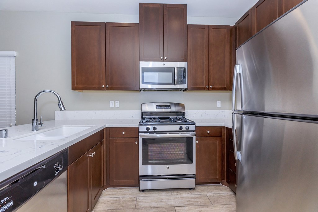a kitchen with stainless steel appliances and wooden cabinets