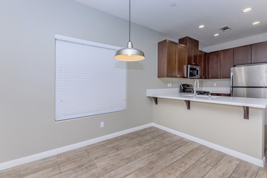 a kitchen with a large window and a sink and a refrigerator