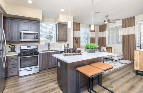 an open kitchen and living room with a table and chairs