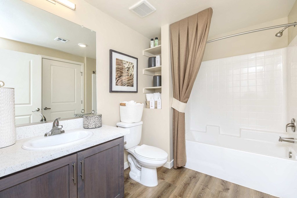 a bathroom with a toilet and a shower and a sink