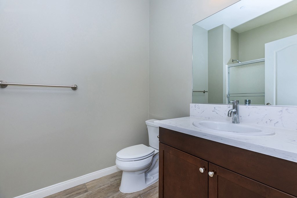 an empty bathroom with a toilet sink and mirror