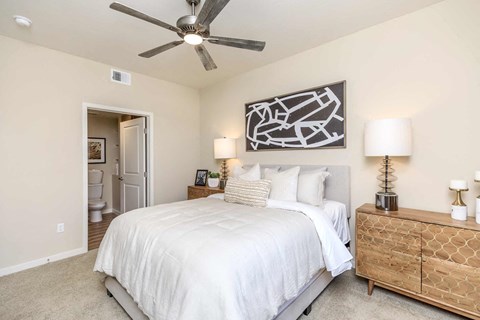 a bedroom with a bed and a ceiling fan