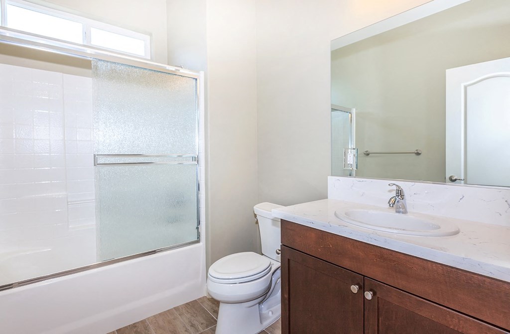 a bathroom with a toilet sink and shower