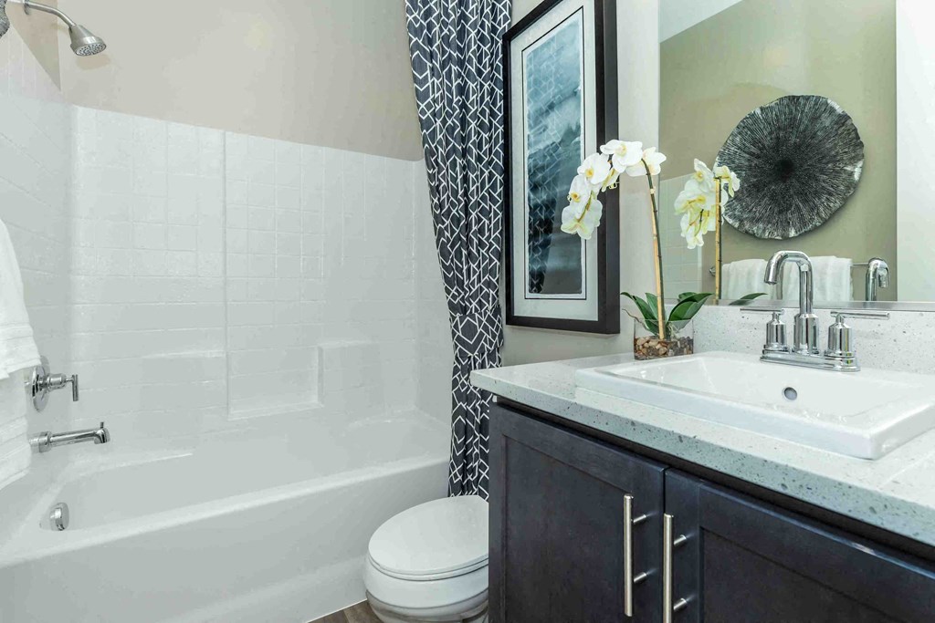 a bathroom with a sink toilet and a bath tub